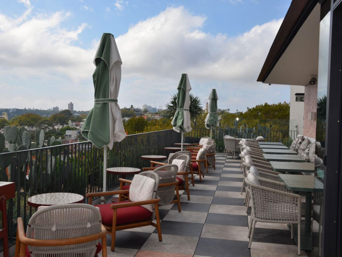 View of the outdoor seating of a restaurant at 25hours Hotel Sydney The Olympia