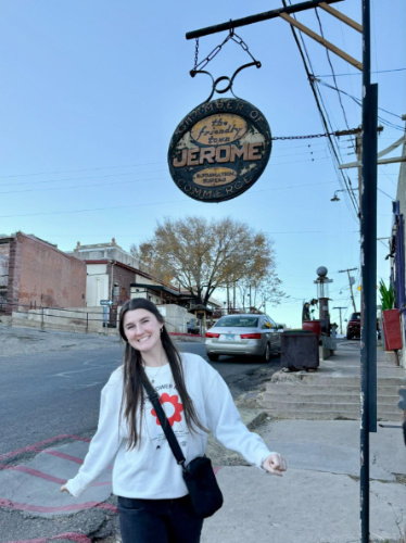The author's best friend smiling for a photo in Downtown Jerome