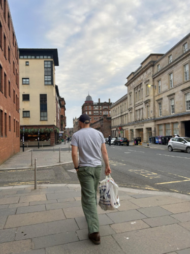 The author's husband holding a grocery bag