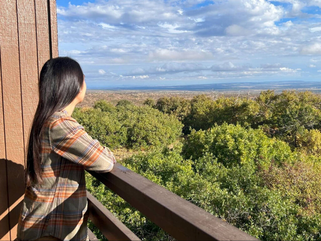 The author Abigail Bliss, admiring the overlooking view from Far View Lodge