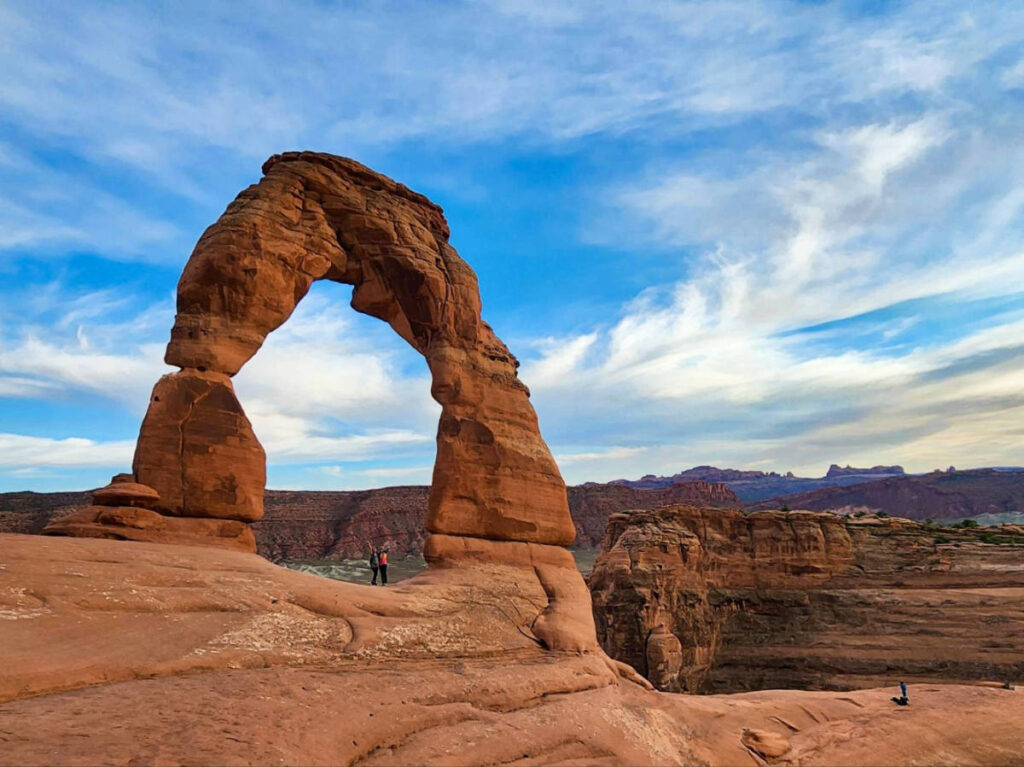 The author Abigail Bliss and her friend, under the Delicate Arch