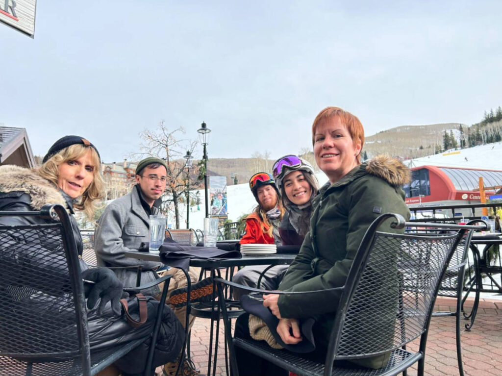 The author Abigail Bliss and her family, posing at the outdoor patio of C Bar