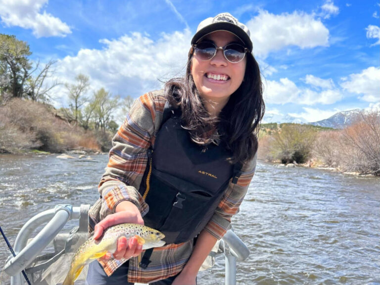 The author Abigail Bliss holding a fish from the boat