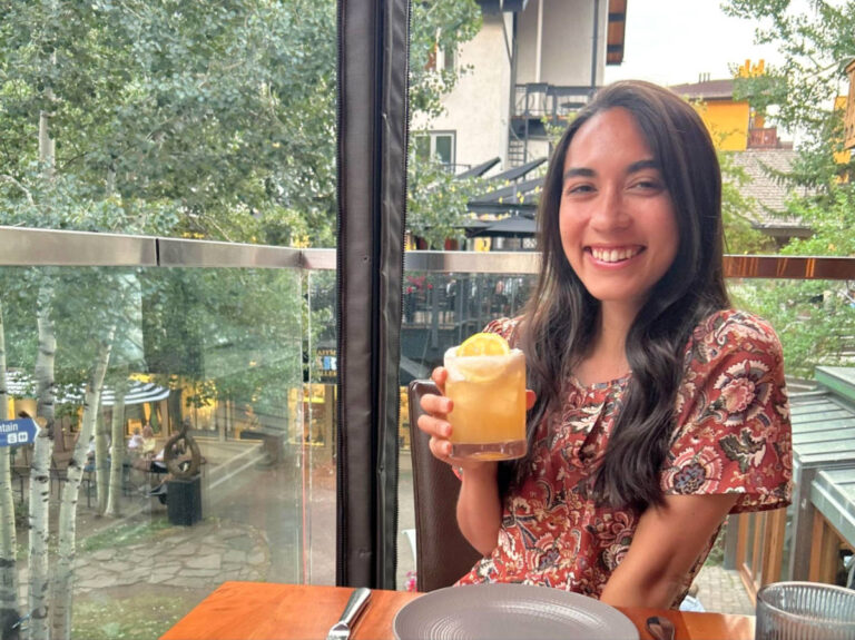 The author Abigail Bliss, holding a drink at Sweet Basil
