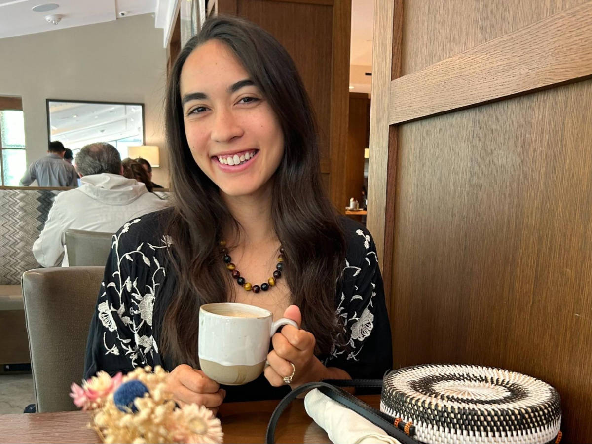 The author Abigail Bliss, holding a cup of coffee in Grand Hyatt Vail