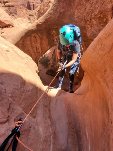 Travel Lemming Editor Abigail Bliss rappelling down the steep cliffs and tight slots