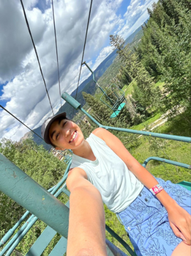 The author Abigail Bliss, smiling for a photo while riding the lift