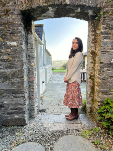 The author Abigail Bliss posing for a photo under the archway