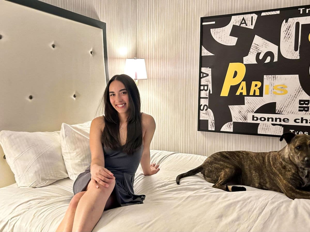 Travel Lemming editor Abigail Bliss and her dog, sitting on the bed in Paris Las Vegas Hotel & Casino