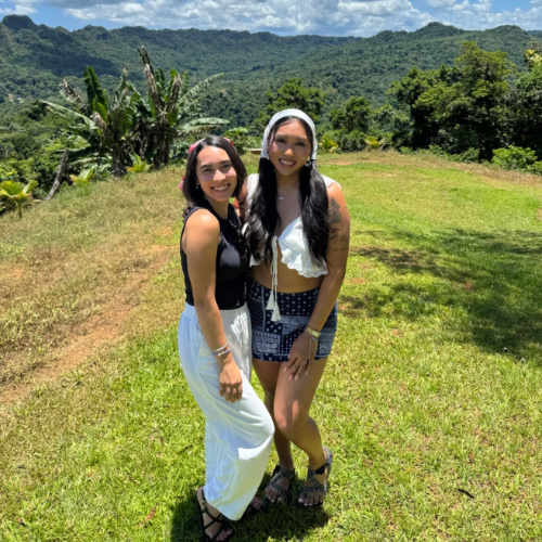 The author Abigail Bliss, wearing a wide leg pants with her friend on a mountain