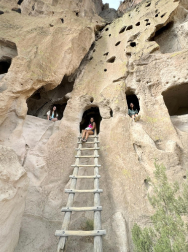 Travel Lemming Editor Abigail Bliss and her friends in the dwelling in Bandelier National Monument