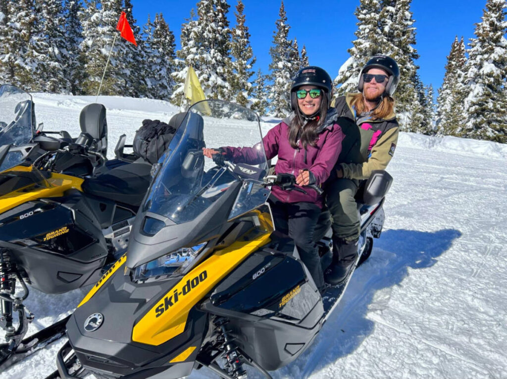 Travel Lemming writer Abigail Bliss and her husband, riding a snowmobile