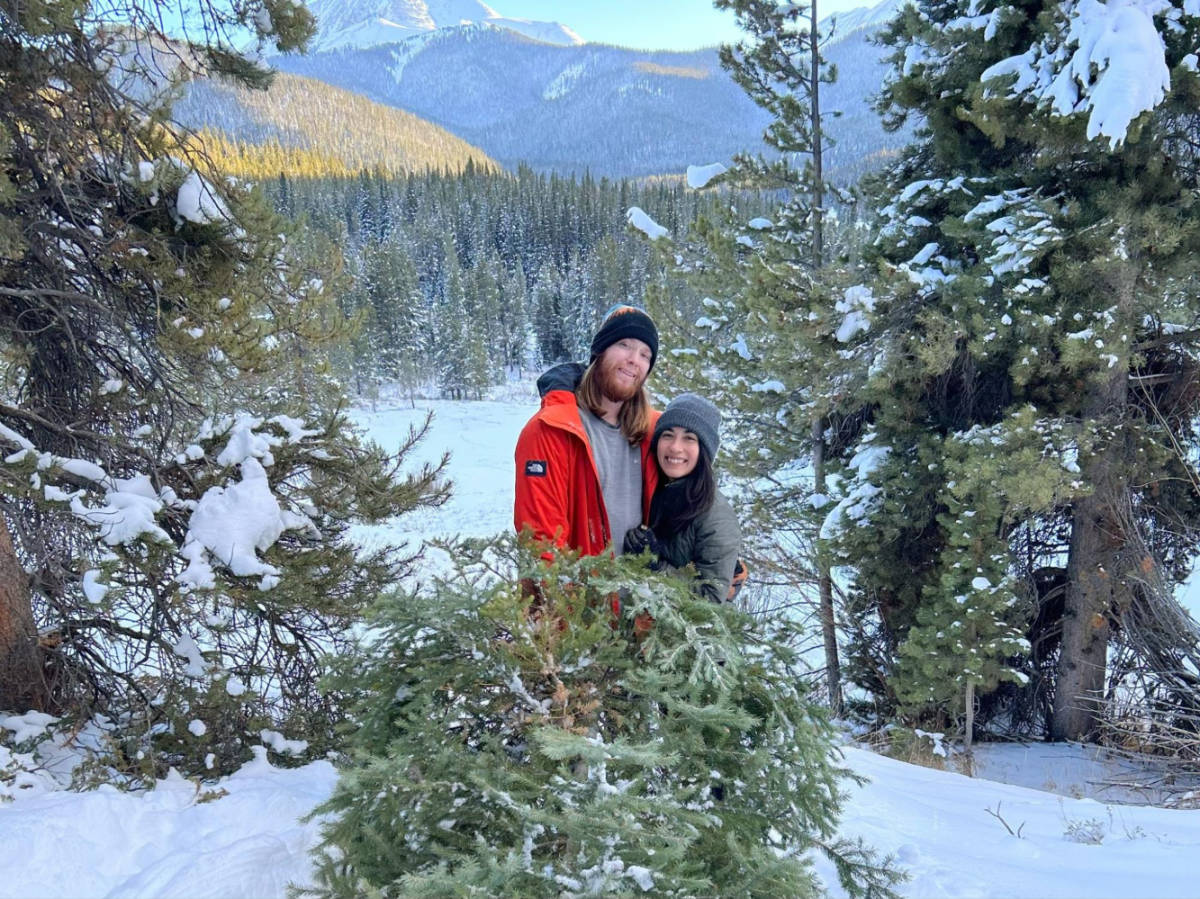 Travel Lemming writer Abigail Bliss and her husband, smiling for a photo at the Christmas tree farm