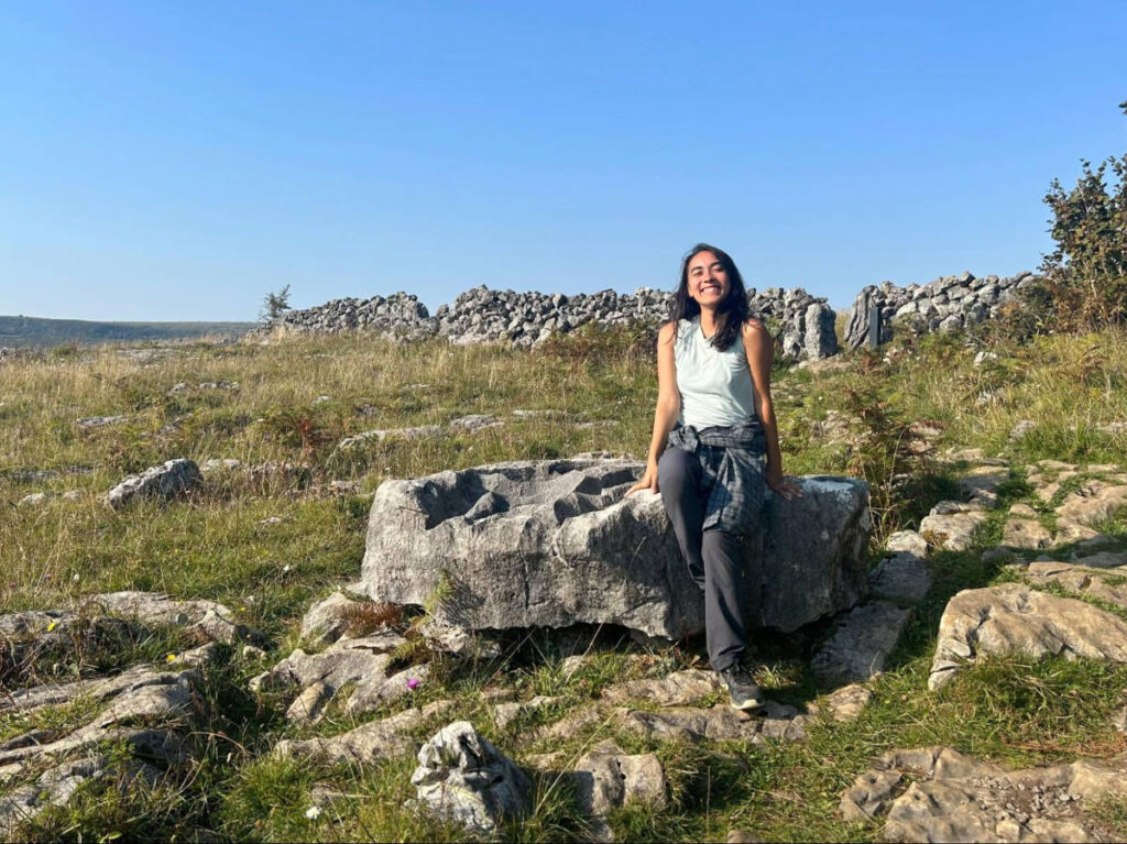 The author Abigail Bliss, posing for a photo on the huge rock at Burren National Park