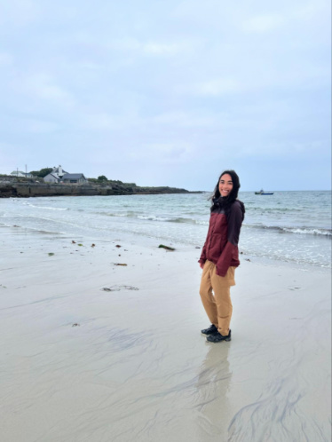 The author Abigail Bliss posing for a photo at the white sand Kilmurvey Beach