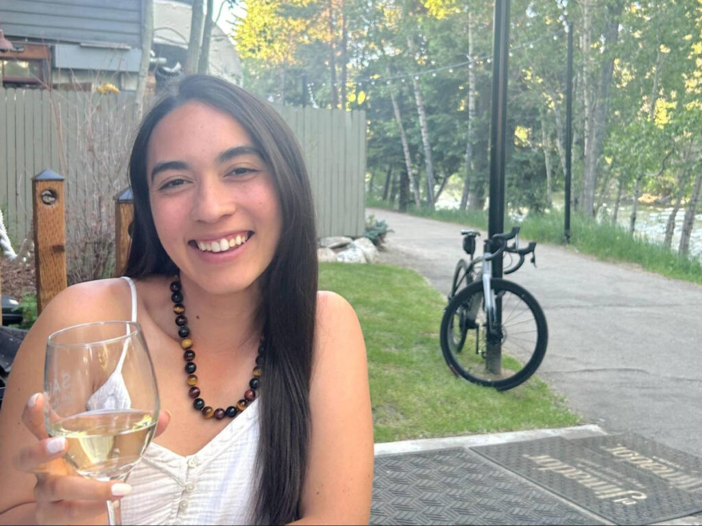Travel Lemming Editor Abigail Bliss, holding a drink at Sauce on the Blue