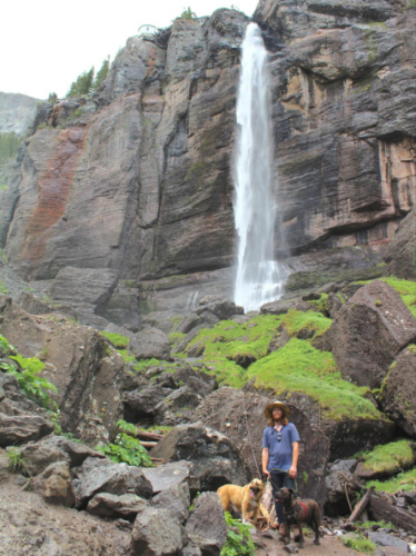 Travel Lemming Editor Abigail Bliss' husband and pups beneath Bridal Veil Falls