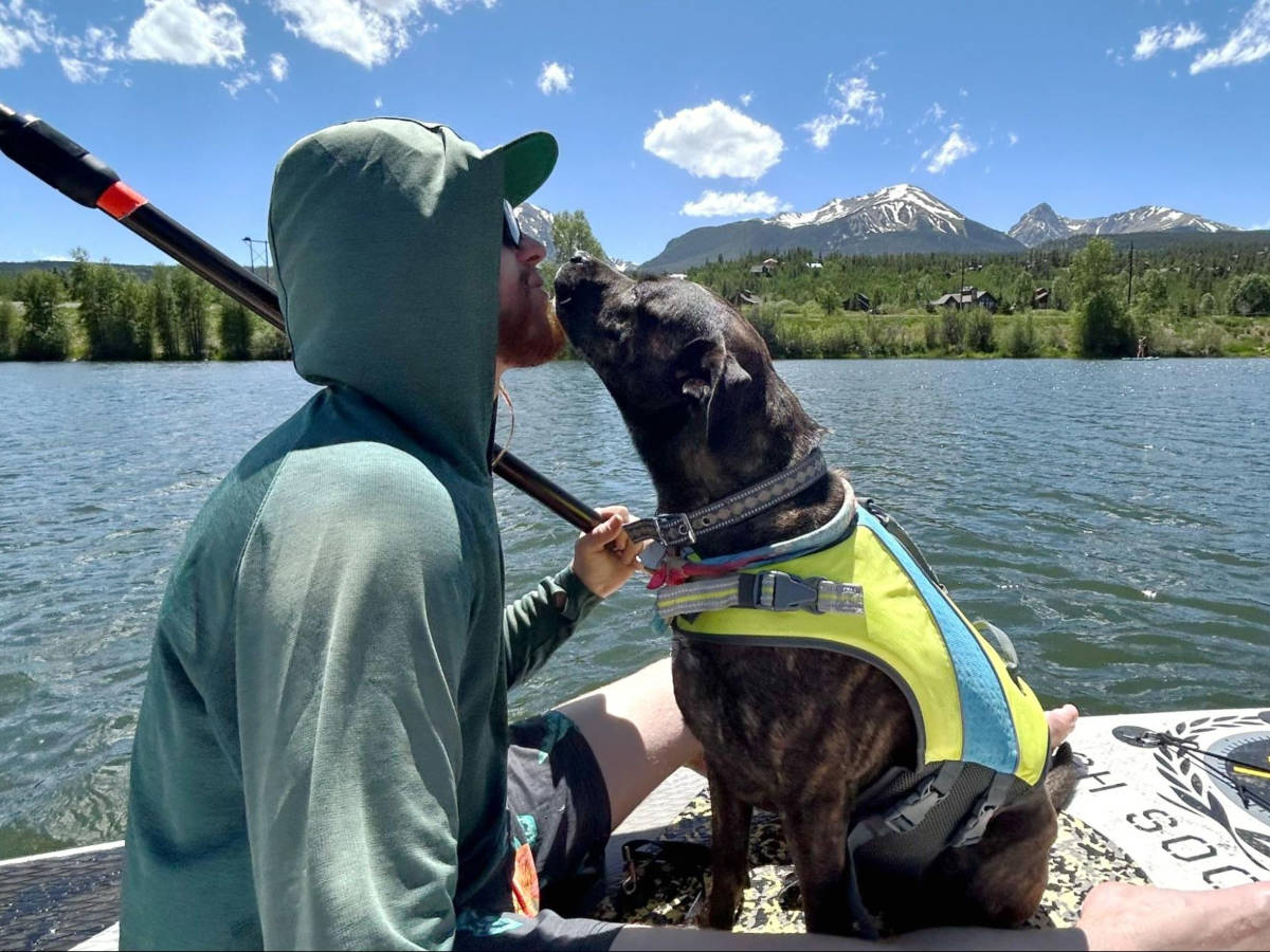 The author's husband and their dog paddle boarding at North Pond Park