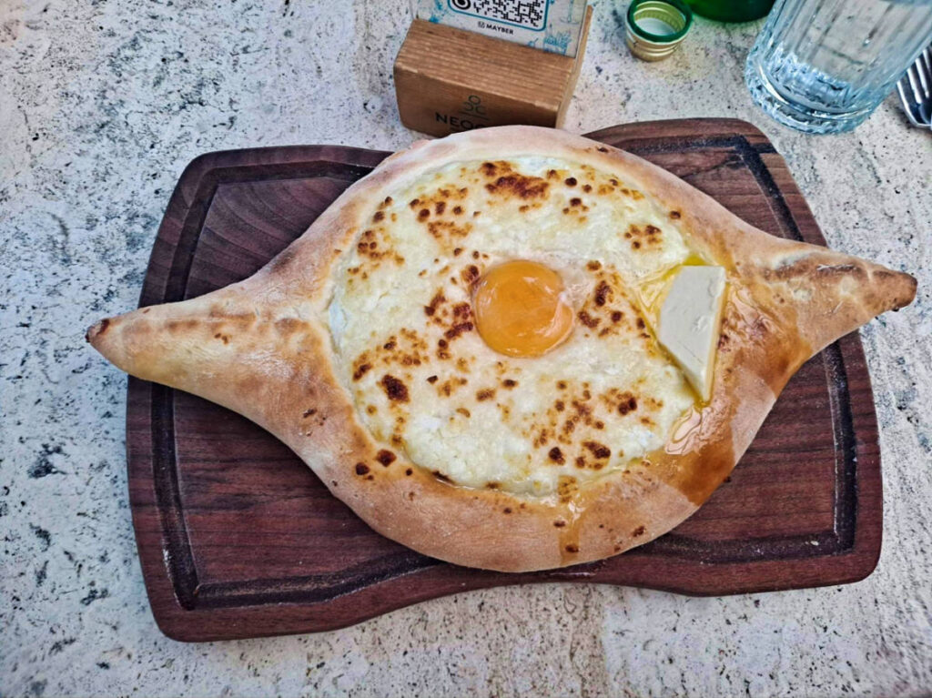 Closeup look of the Adjarian Khachapuri on a wooden board
