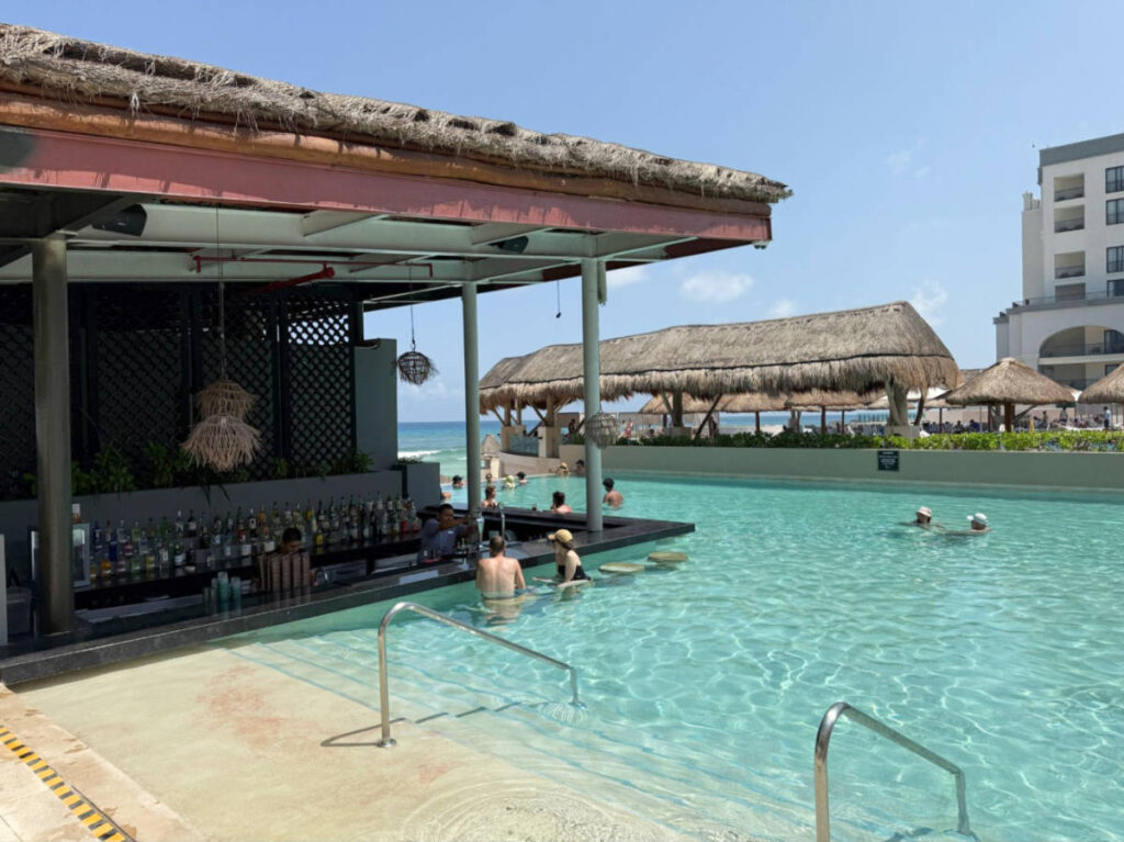 People swimming and enjoying the bar at the adults-only pool in Marriott Cancun