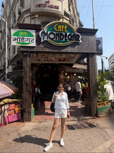 The author Advaita, smiling for a photo in front of the Cafe Mondegar