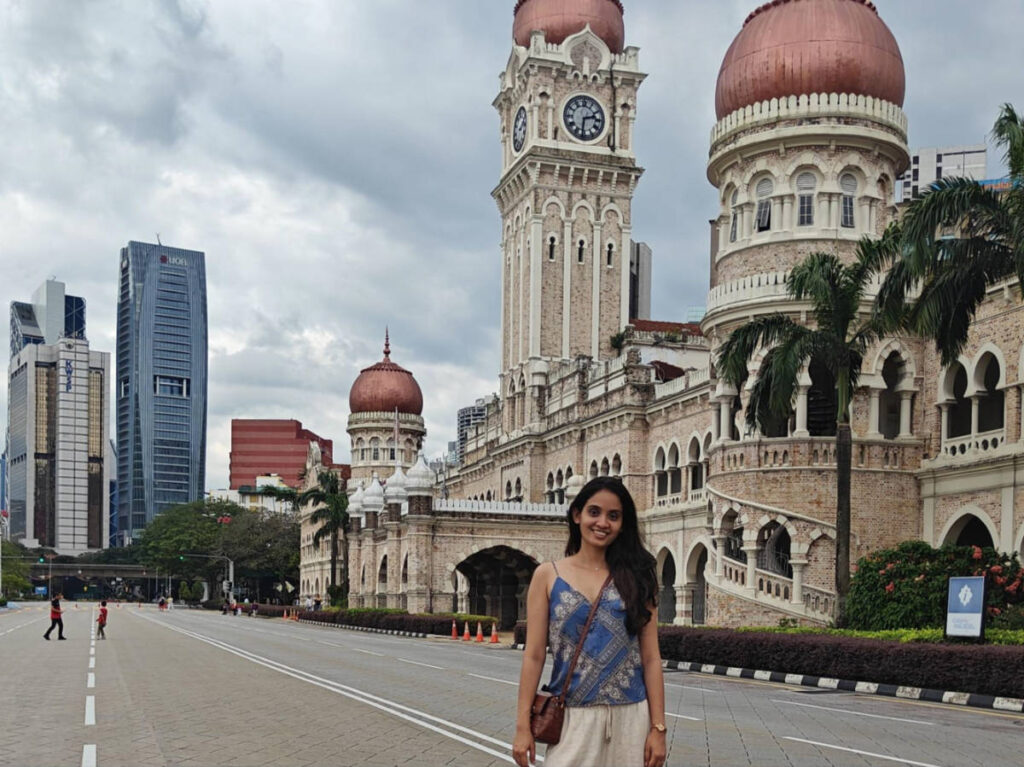 The author, Advaita, posing for a photo in front of the Sultan Abdul Samad Building at Merdeka Square