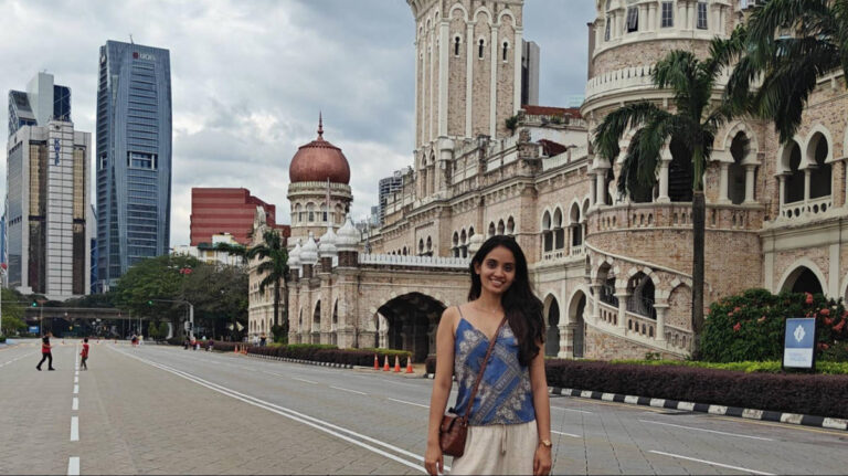 The author, Advaita, posing for a photo in front of the Sultan Abdul Samad Building at Merdeka Square
