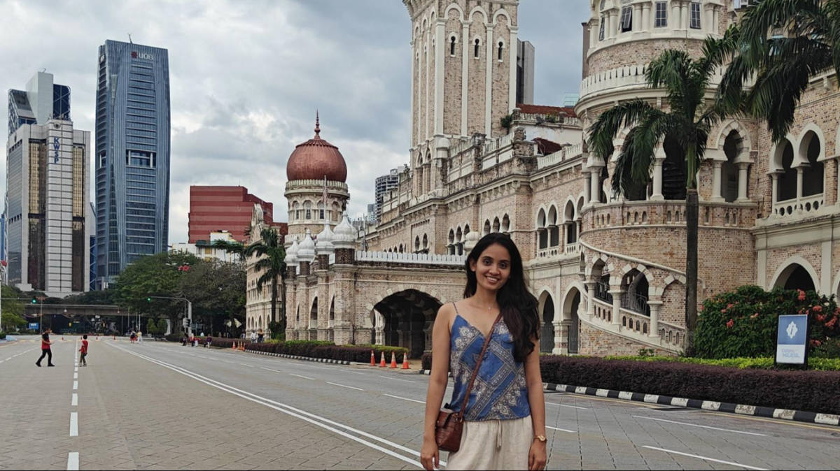 The author, Advaita, posing for a photo in front of the Sultan Abdul Samad Building at Merdeka Square