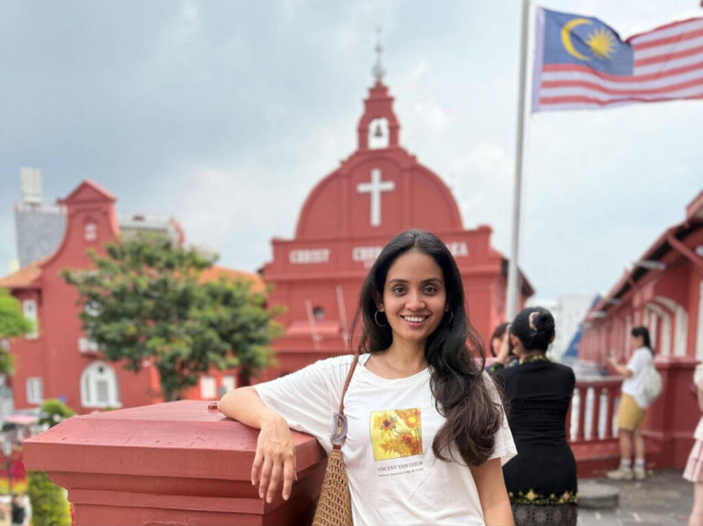 The author, Advaita, posing for a photo in front of the Christ Church at the Dutch Square