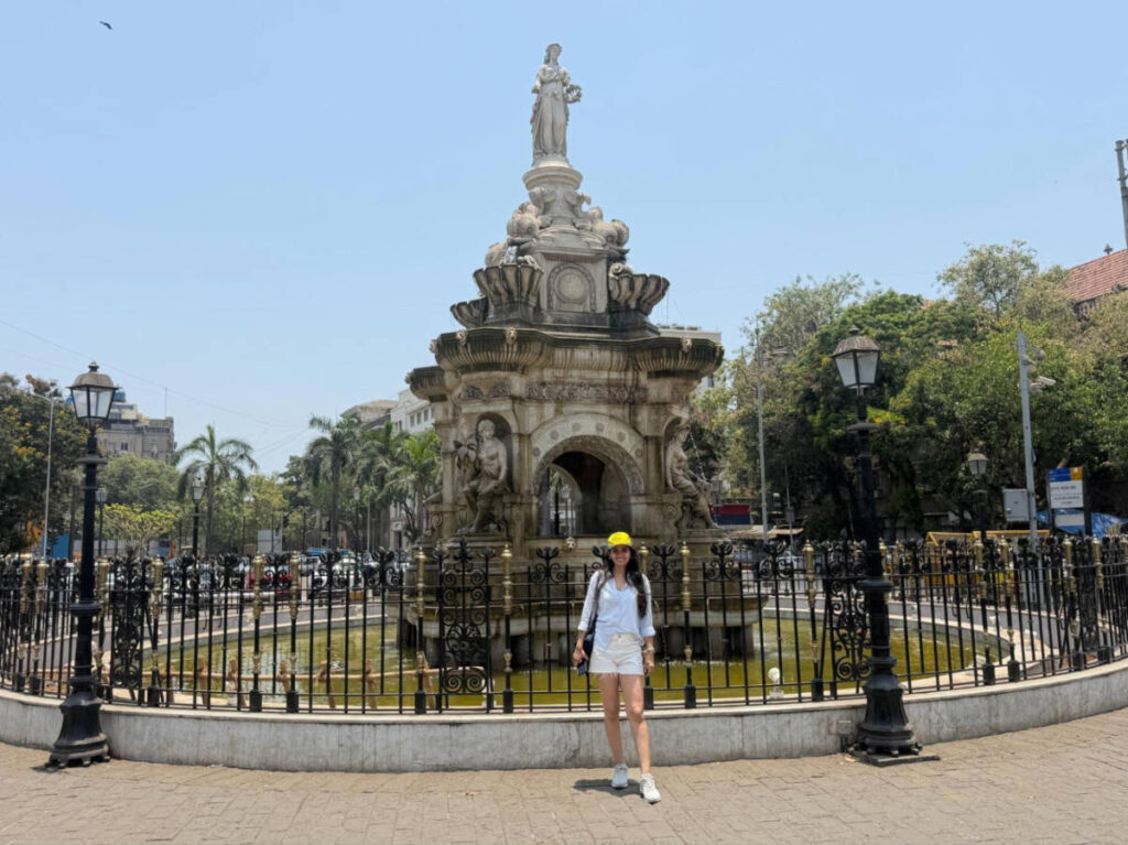 The author Advaita, posing for a photo in front of the Flora Fountain at Mumbai's Fort