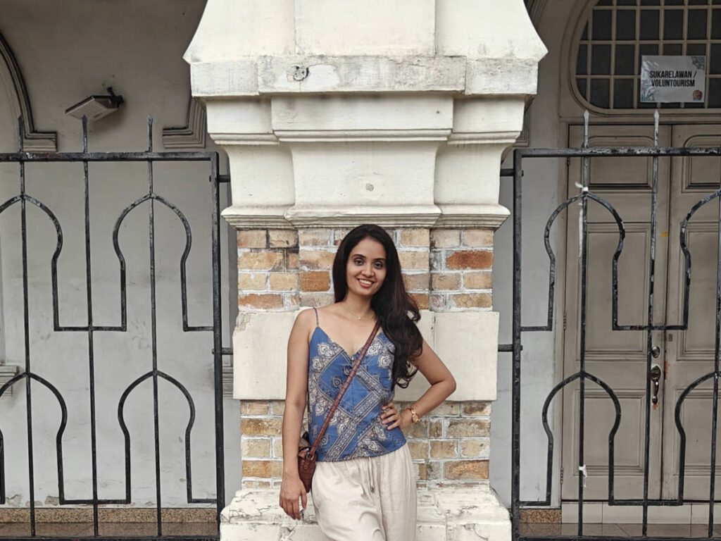 The author, Advaita, posing for a photo at a historic quarter in Merdeka Square