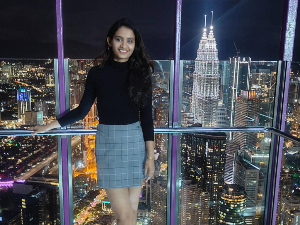 The author, Advaita, enjoying the night view of the city center and Petronas Towers from the KL Tower Sky Box