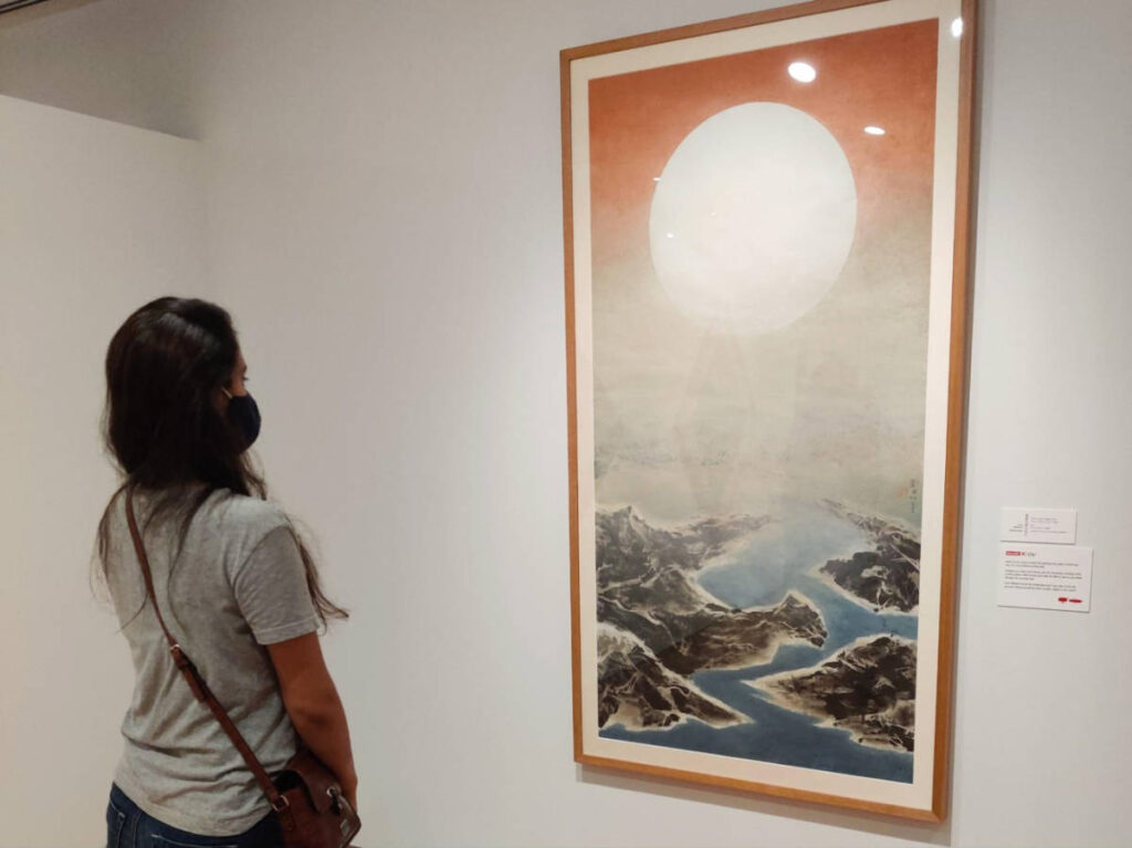 The author Advaita, looking at the painting at the National Gallery Singapore