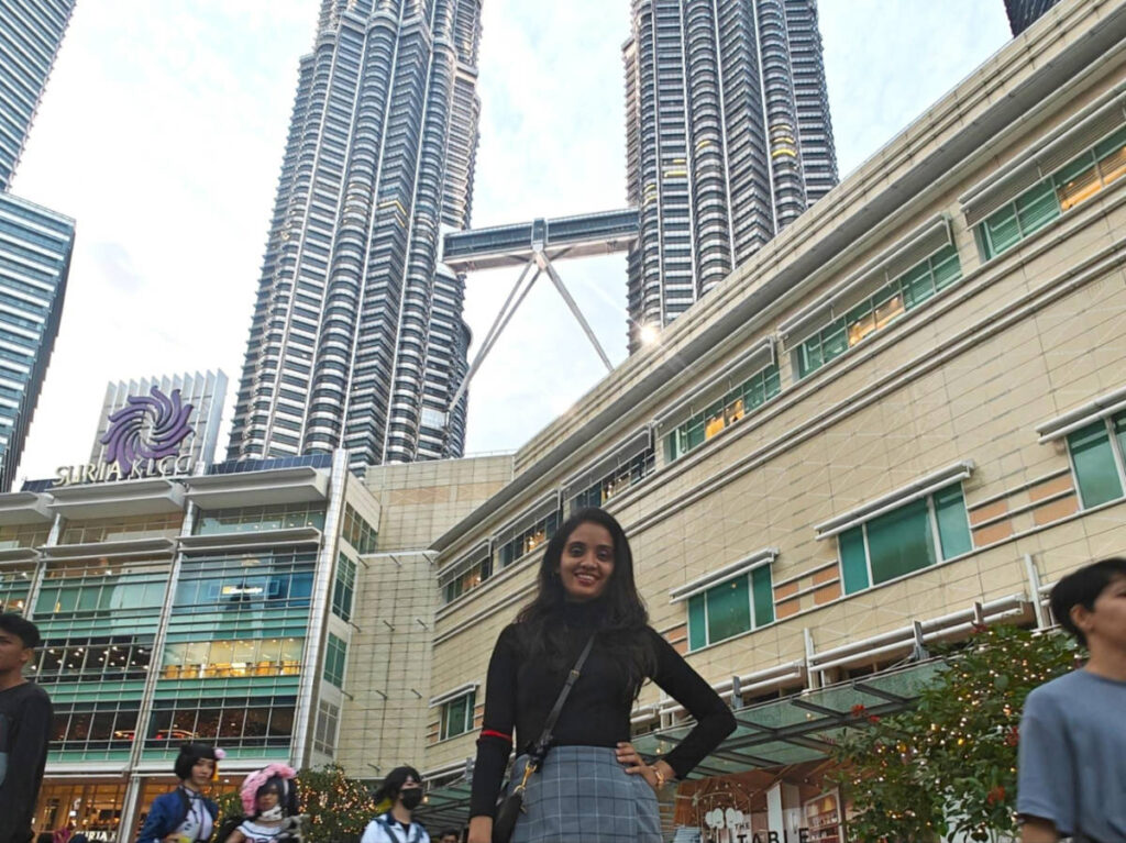 The author, Advaita, posing for a photo outside the Petronas Twin Towers