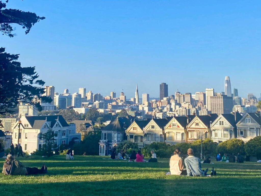 Clear sky over the couples that's having a picnic in Alamo Square Park