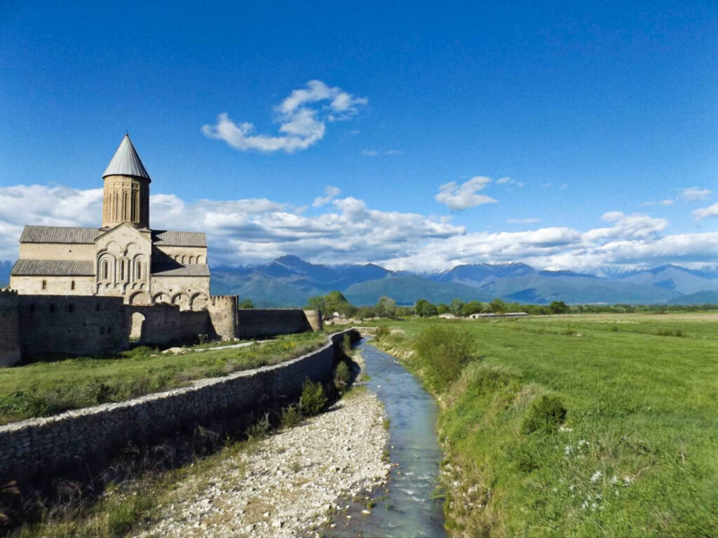 View of the Alaverdi Cathedral near a river with mountain views in the background