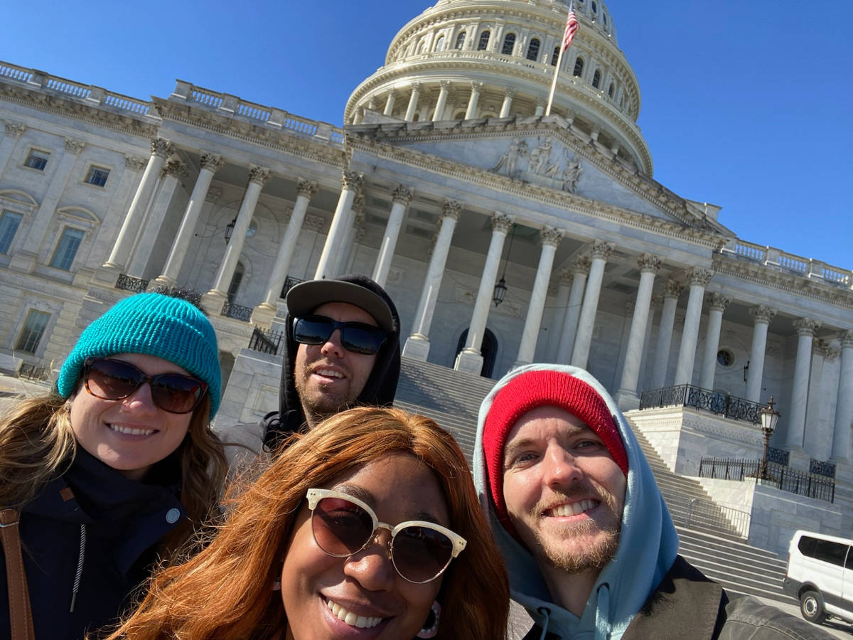The author Alexandria Taylor and her friends smiling for a photo outside the Capitol Building