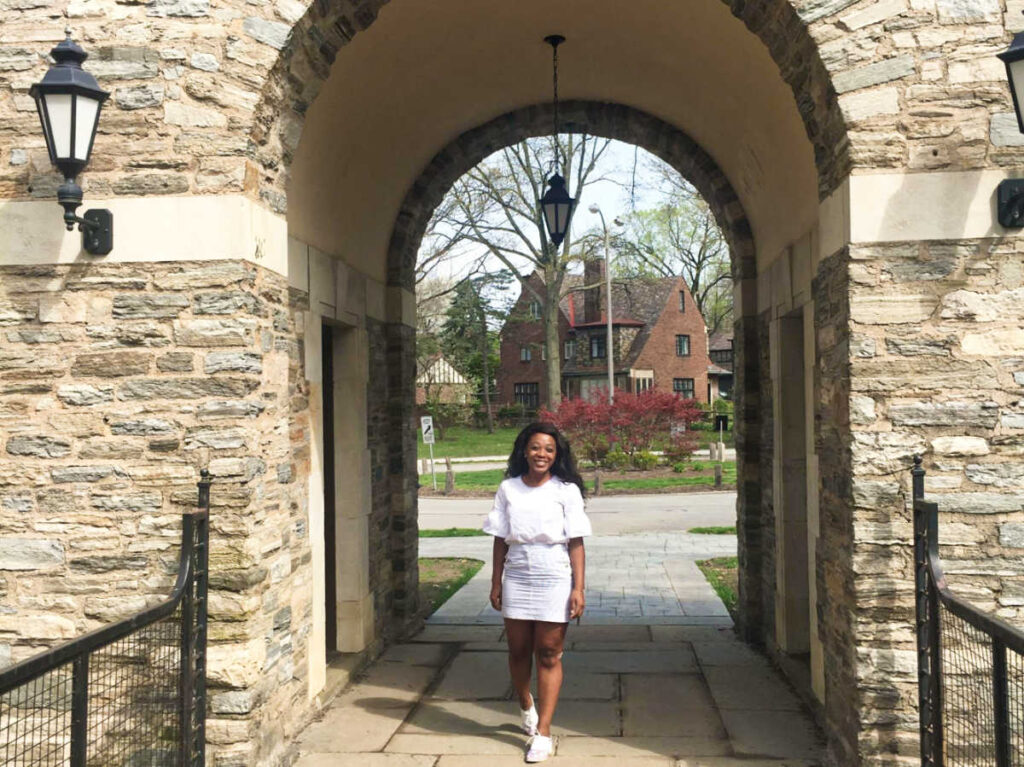 The author Alexandria Taylor, posing for a photo at the entrance to Frick Park