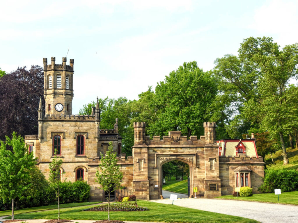 Panoramic view of the entrance to the Allegheny Cemetery surrounded by greenery