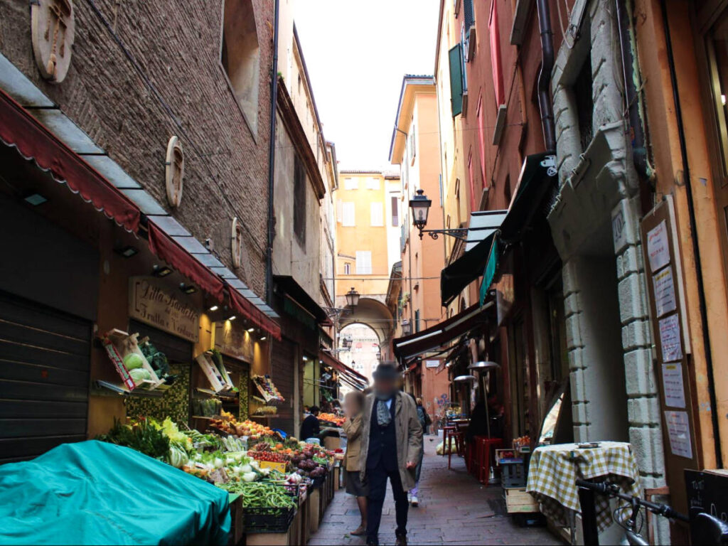 People walking along the alleyway in Bologna