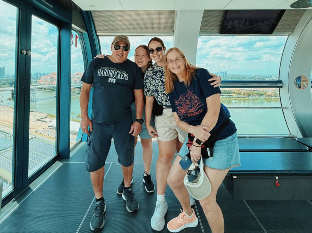 The author Allie Hubers and her family smiling for a photo in the Singapore Flyer