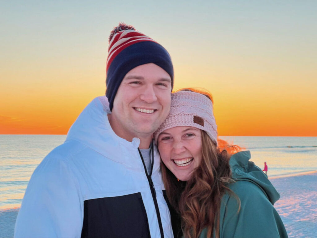 Author Allie and her husband on the beach during Christmastime