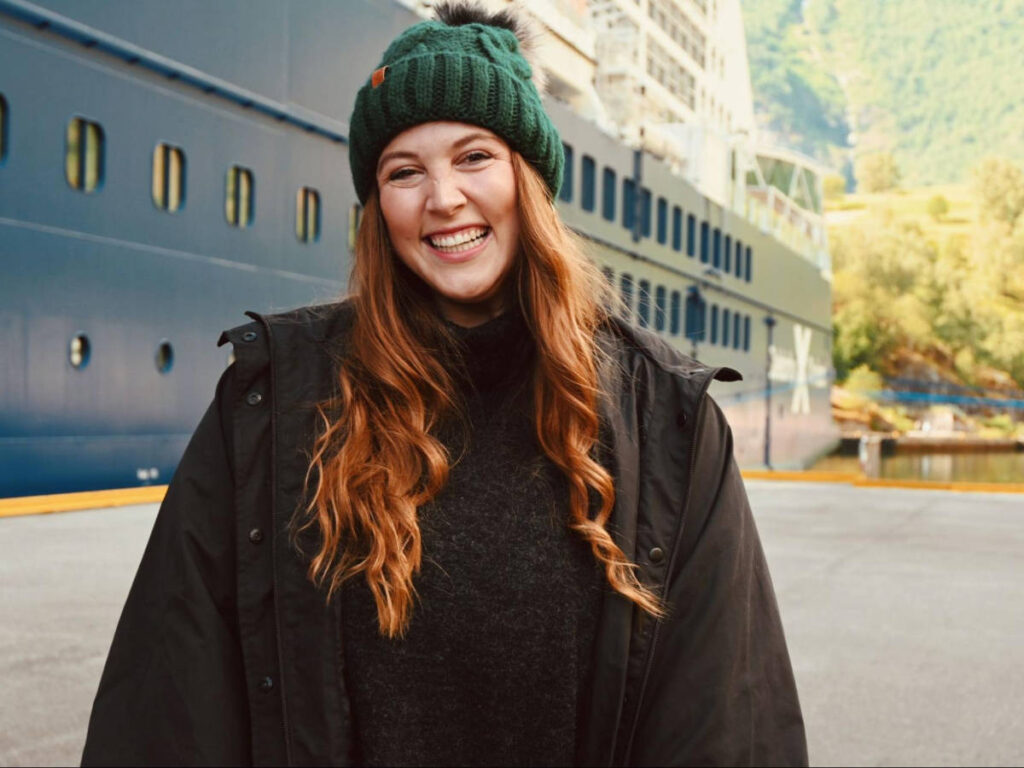 The author Allie Hubers, smiling for a photo in Flam