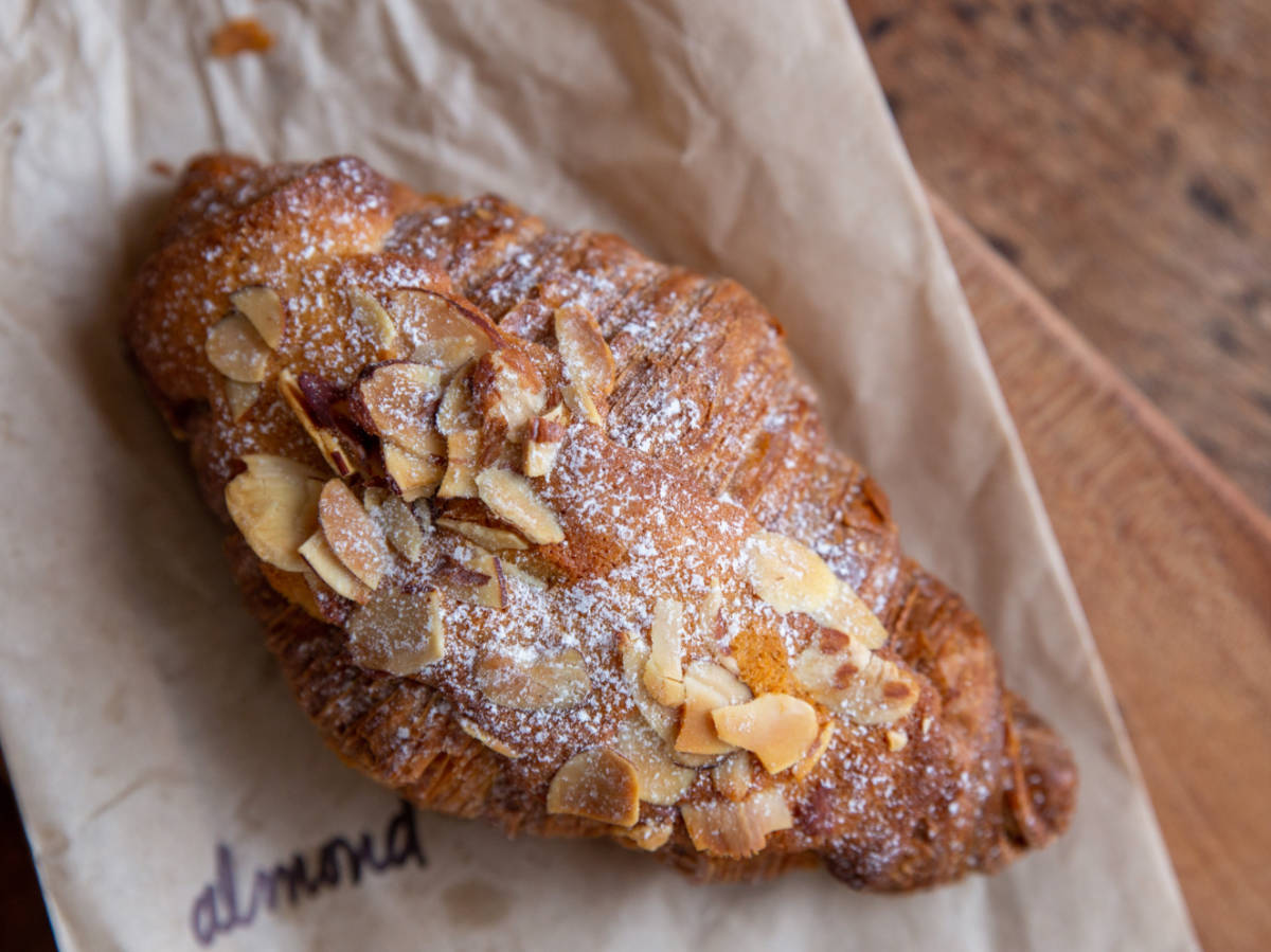 An Almond croissant on a paper bag