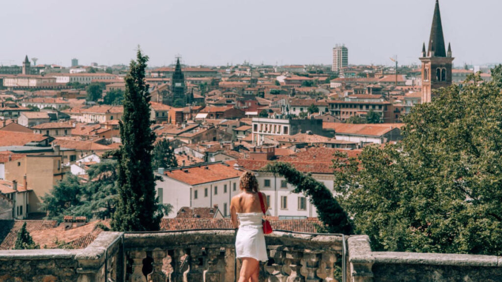 The author Amber Visch, overlooking the cityscape of Verona from a balcony