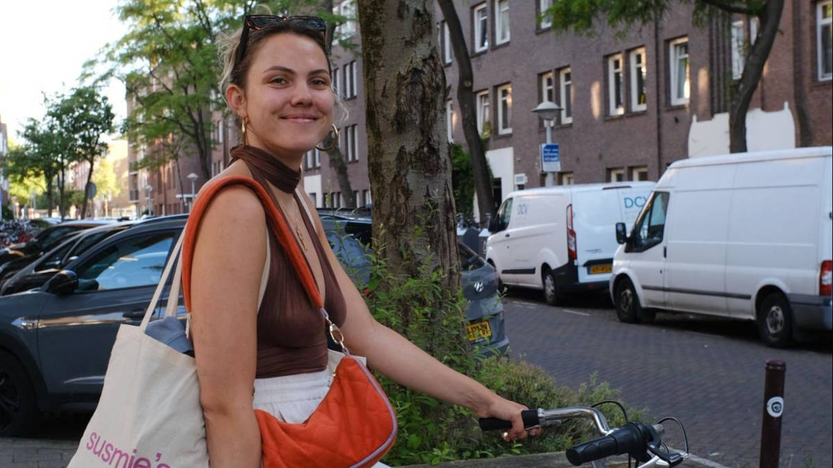 The author Amber Visch, riding a bicycle in Amsterdam