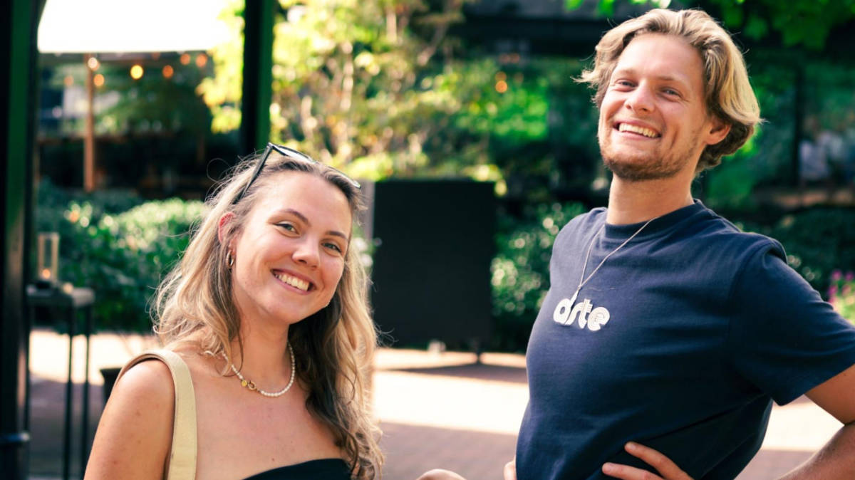 The author Amber Visch and her boyfriend, smiling for a photo at Bar Beaune