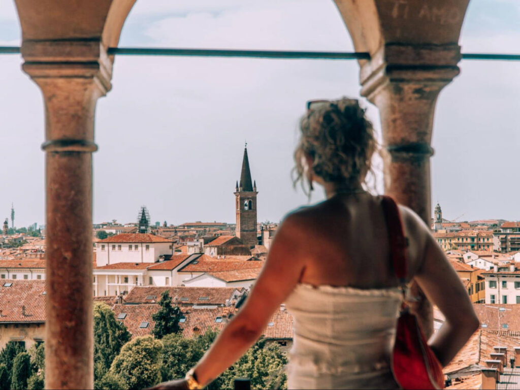 The author Amber Visch, overlooking the city from the window arch at Giardino Giusti