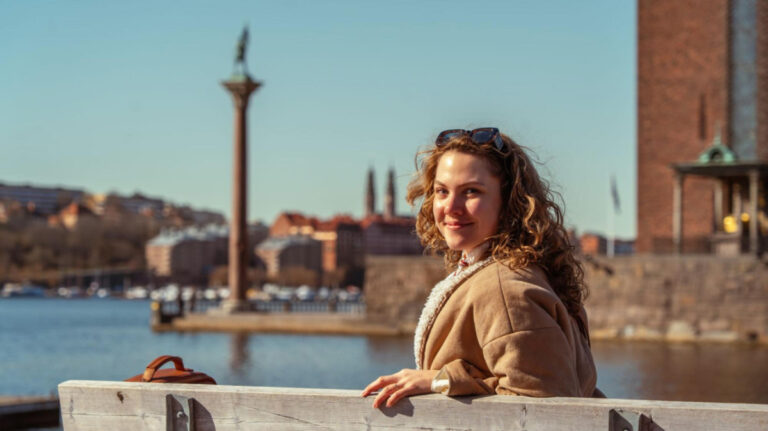 The author Amber Visch, enjoying the skyline views at a waterfront in Stockholm