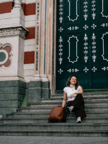 The author Amber Visch, sitting on the steps outside the Santuario Nuestra Señora del Carmen